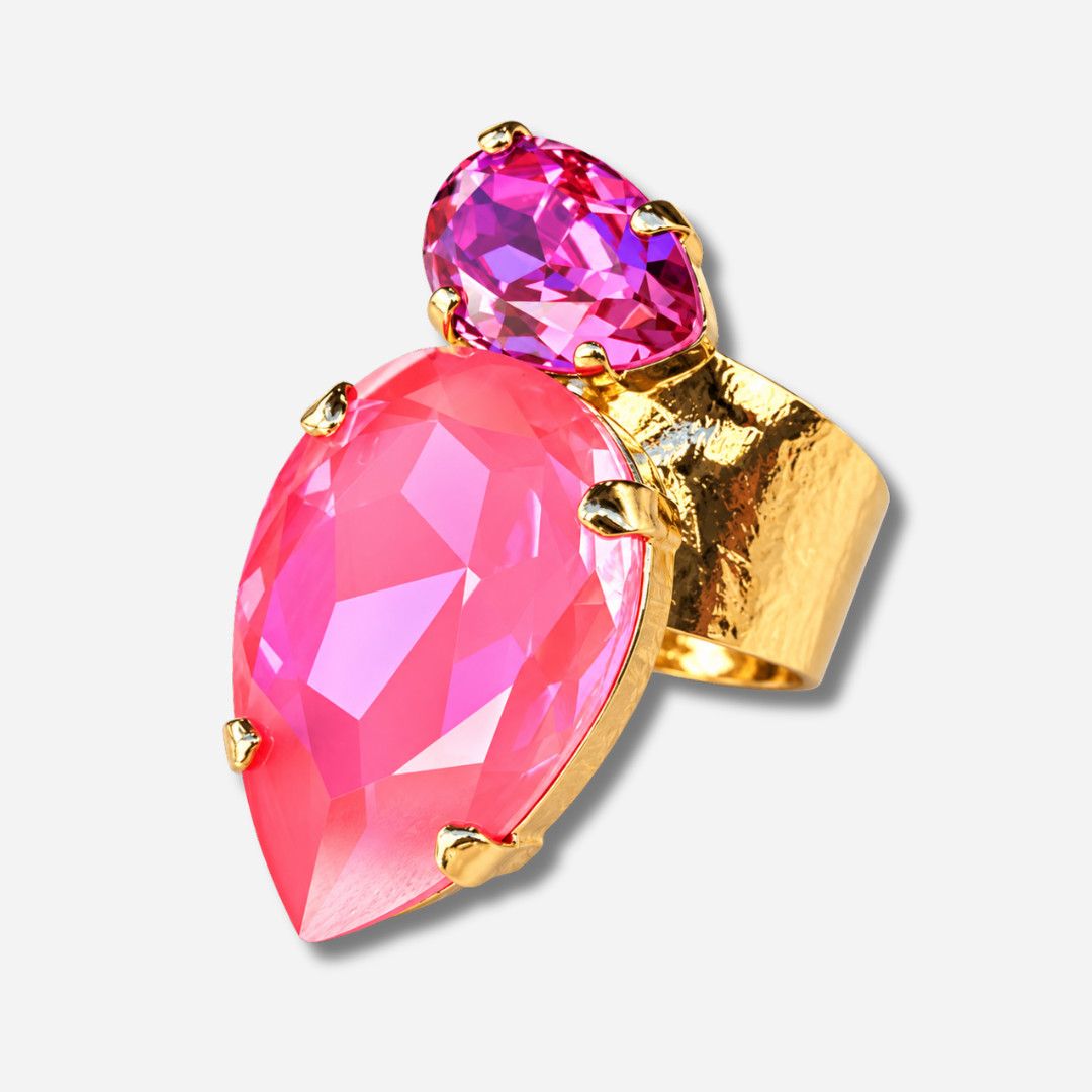 Bague Calypso Orchidée Crézus avec grand cristal rose orchidée en forme de goutte, petit cristal rose fuchsia facetté, sertissage à griffes dorées et anneau large martelé.