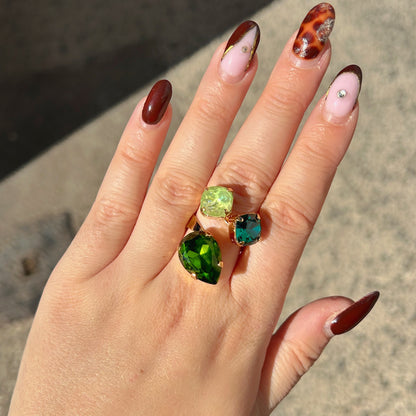 Bague Dalia Émeraude Crézus ornée de trois cristaux facettés vert émeraude, vert anis et vert olive, sertis sur une monture dorée asymétrique – Divinity Sète.