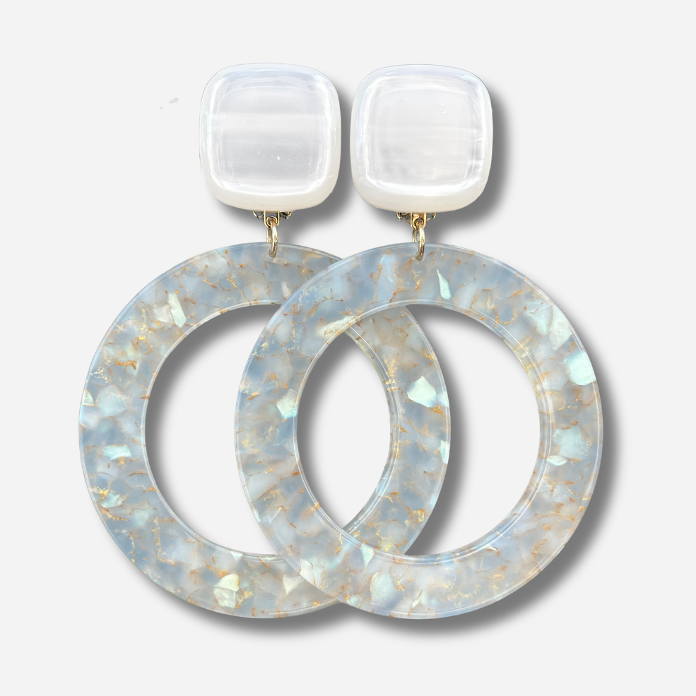 Boucles d'oreilles Cécilia Irisée XL Francine Bramli Paris en résine blanche avec grands anneaux translucides aux reflets nacrés et dorés.