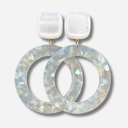 Boucles d'oreilles Cécilia Irisée XL Francine Bramli Paris en résine blanche avec grands anneaux translucides aux reflets nacrés et dorés.