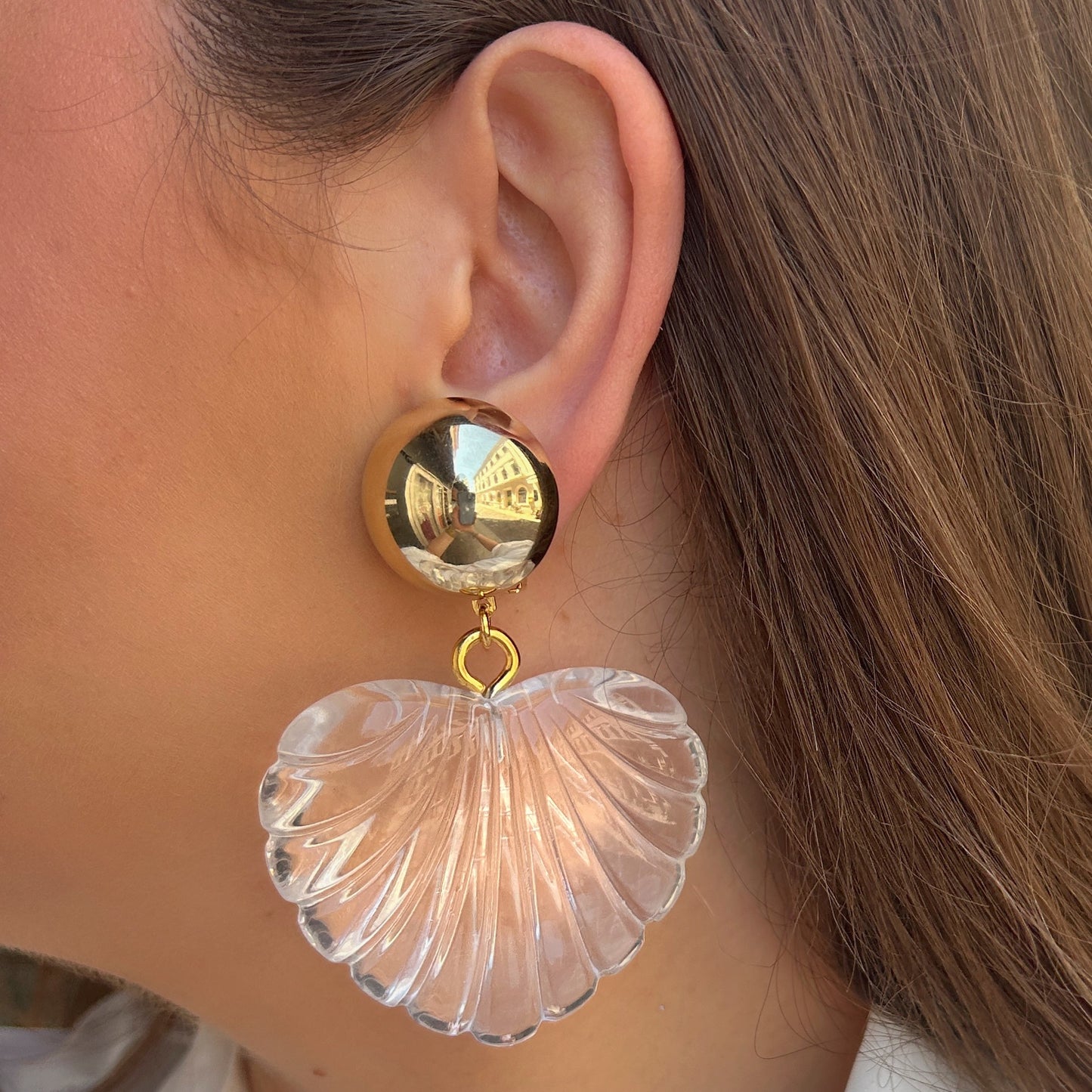 Boucles d'oreilles Heart Cristal Francine Bramli Paris avec puce ronde dorée miroir et grand pendentif cœur transparent en résine sculptée.
