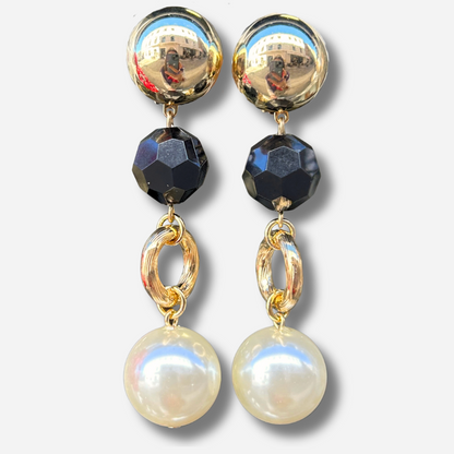 Boucles d'oreilles à clips Anastatia Perles Noir Francine Bramli Paris avec bouton rond doré effet miroir, perle noire facettée, anneau ovale doré et grande perle nacrée ivoire – Divinity Sète.