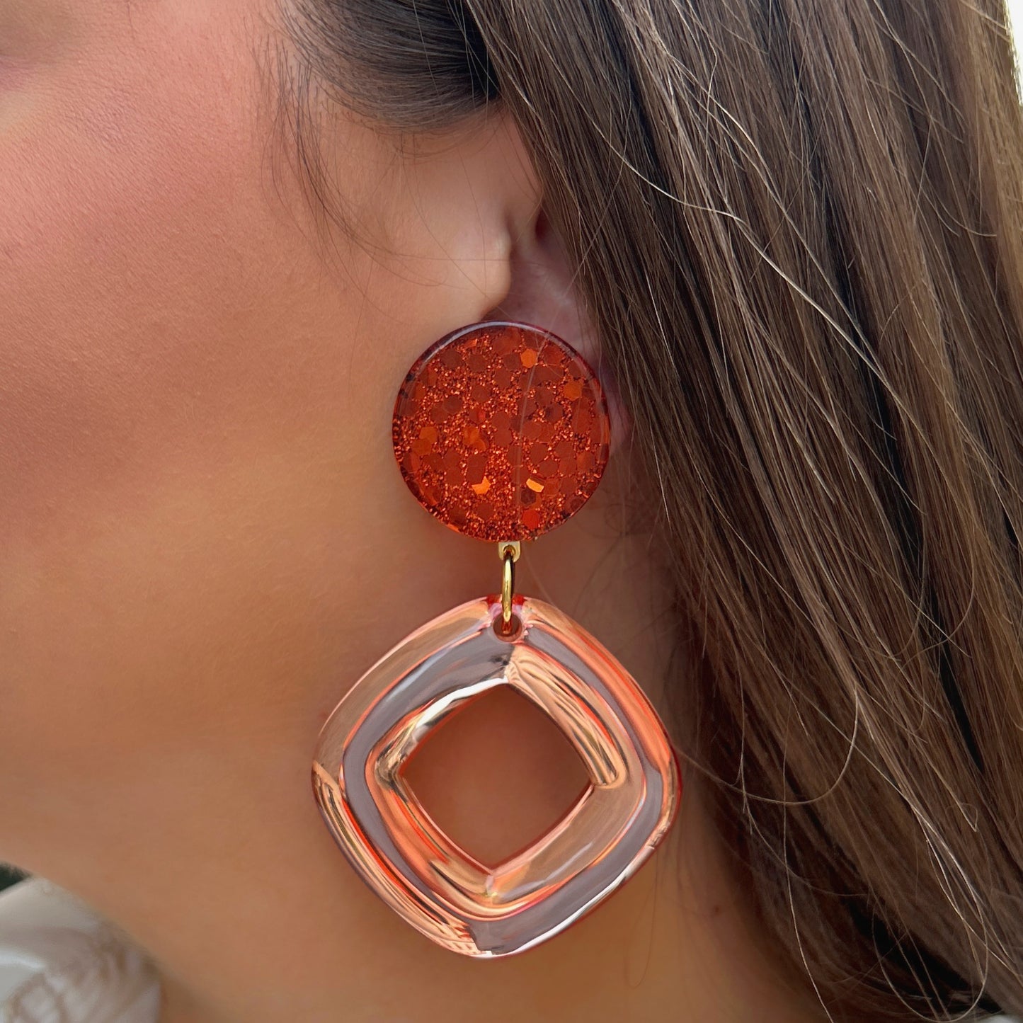 Boucles d'oreilles Asteria Rouge Orange Francine Bramli en résine pailletée orange avec grand anneau carré translucide pêche