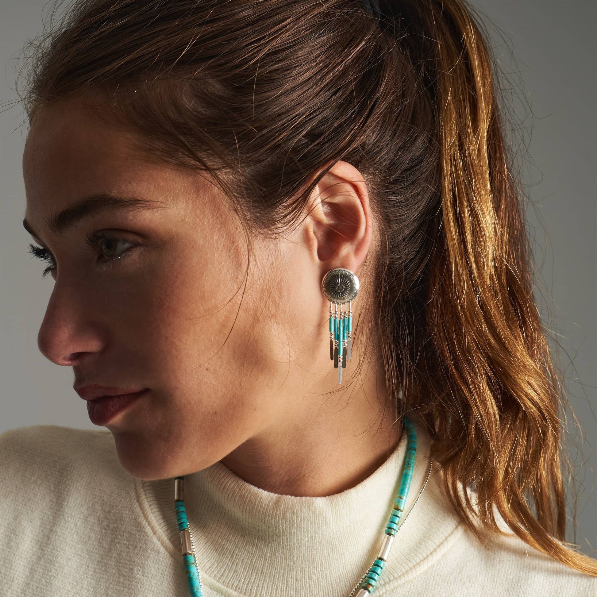 Boucles d’oreilles E310 Concha Turquoise Harpo en argent massif avec médaillons concha gravés, perles turquoise et pampilles en liquid silver.