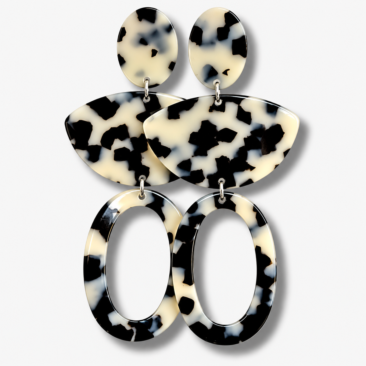 Boucles d’oreilles Luna XL Écaille Noir et Blanc à clips Francine Bramli Paris, modèle XXL composé de trois éléments articulés en résine effet écaille et de grands anneaux ovales ajourés.
