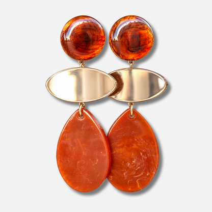 Boucles d’oreilles Marselline Marron à clips Francine Bramli Paris, cabochons ronds ambrés, ovales dorés effet miroir et grandes gouttes en résine orange cuivré.