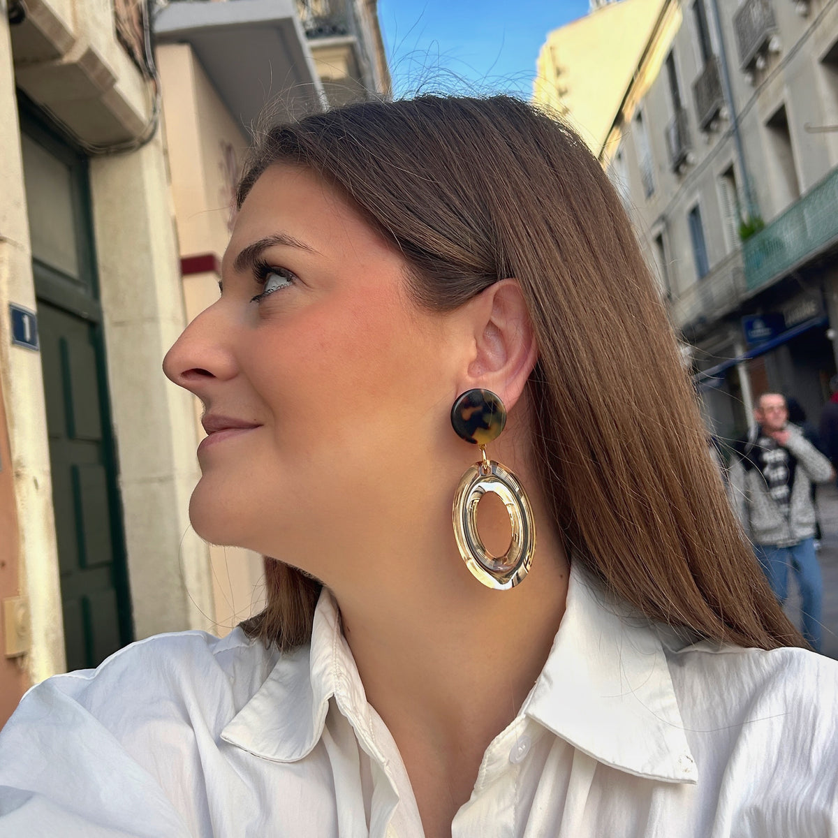 Boucles d’oreilles Vivas Champagne à clips Francine Bramli Paris, cabochons ronds effet écaille marron et ambre et grands anneaux ovales transparents champagne.