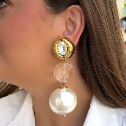 Boucles Yaelle Perles Francine Bramli Paris avec cristal transparent, monture dorée et grande perle nacrée blanche pendante.
