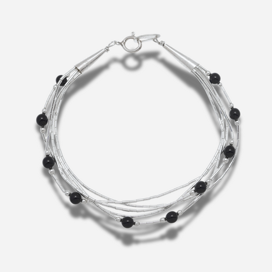 Bracelet B487 Harpo en argent massif liquid silver avec perles d’onyx noir fabriqué à la main selon la tradition Navajo.