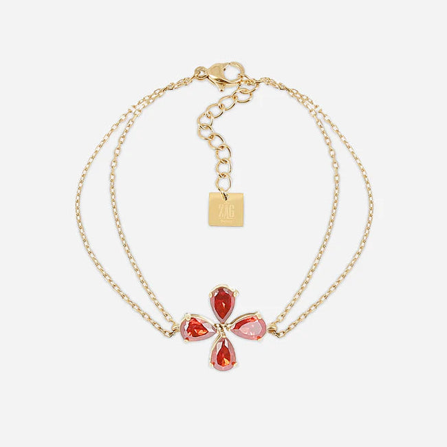 Bracelet Estial ZAG en acier inoxydable doré avec fleur à quatre pétales en cristaux