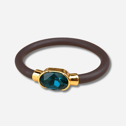 Bracelet Gala Bleu Pétrole avec cristal ovale facetté bleu profond, monture dorée et bracelet marron