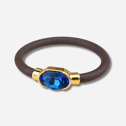 Bracelet Gala Bleu Saphir avec cristal ovale facetté bleu intense, monture dorée et bracelet marron