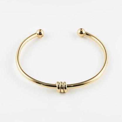 Bracelet jonc Pei ZAG acier inoxydable doré jonc ouvert avec embouts boule et anneaux femme Divinity Sète