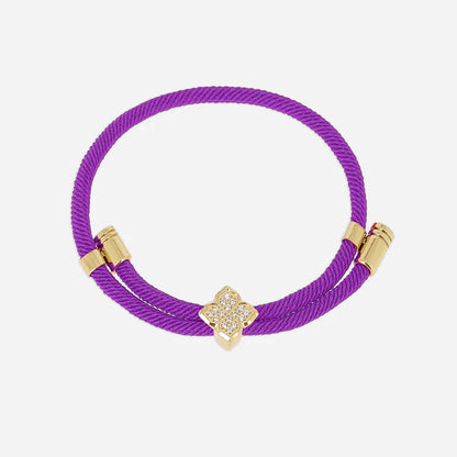 Bracelet Rezza ZAG en acier inoxydable doré avec motif trèfle serti de zirconiums et cordon coloré