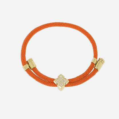 Bracelet Rezza ZAG en acier inoxydable doré avec motif trèfle serti de zirconiums et cordon coloré