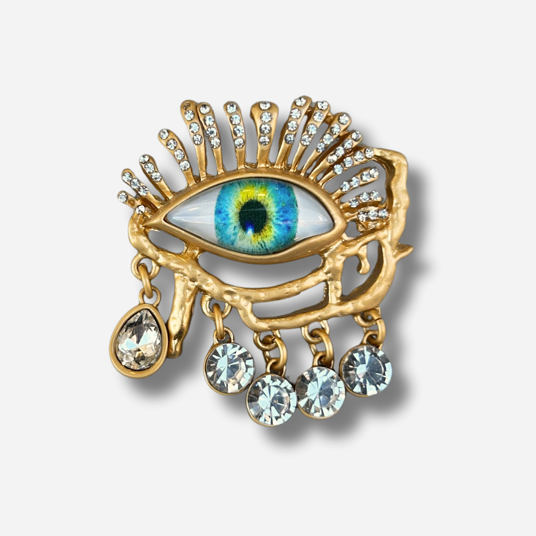 Broche bijou femme œil doré avec pampilles strass
