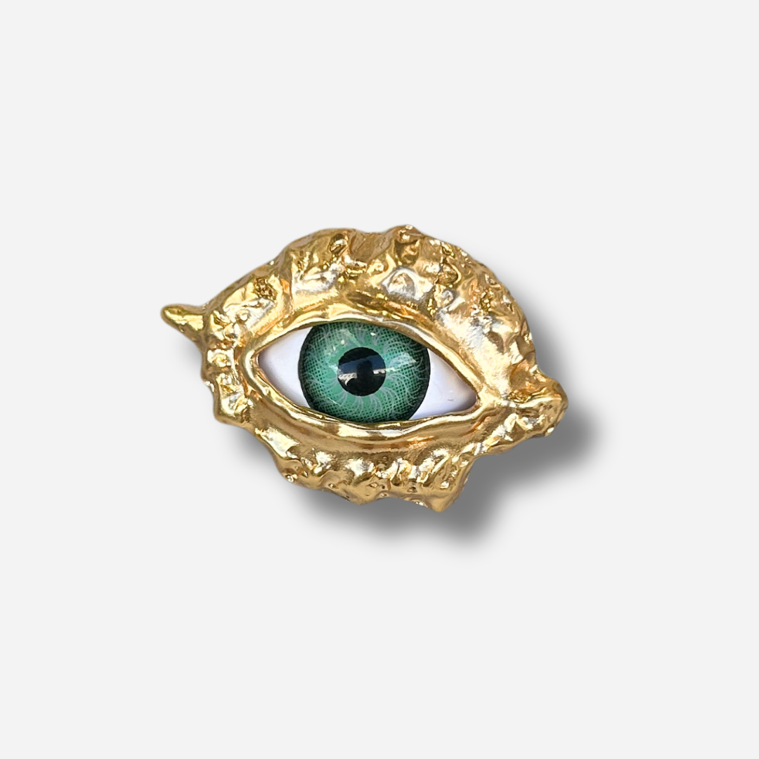 Broche bijou femme œil vert monture dorée texturée
