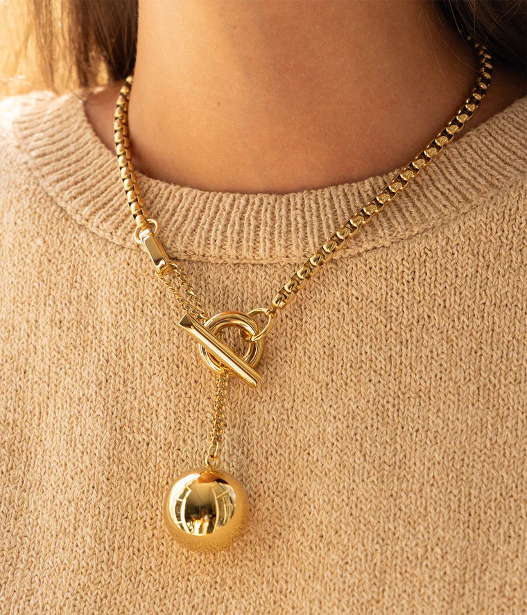 Collier Muse Zag porté chaîne dorée fermoir T-bar