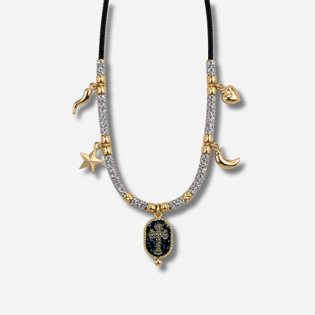 ALT : Collier Palombaggia Croix Noir Amadrina avec médaillon croix dorée sur fond noir pailleté
