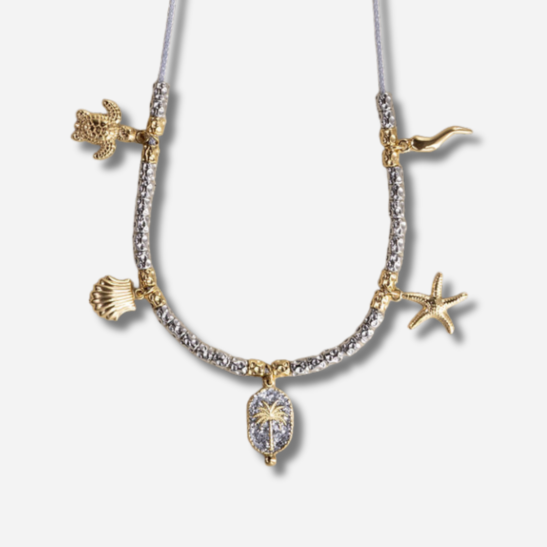 Collier Palombaggia Palmier Argent Amadrina en acier doré 18K avec cristaux argentés, palmier central et pampilles marines