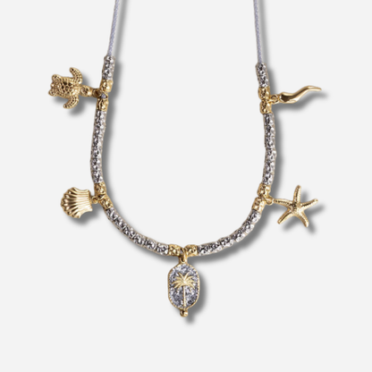 Collier Palombaggia Palmier Argent Amadrina en acier doré 18K avec cristaux argentés, palmier central et pampilles marines