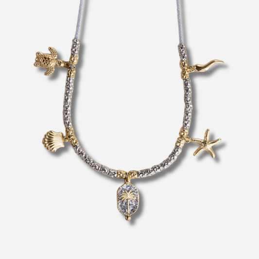 Collier Palombaggia Palmier Argent Amadrina en acier doré 18K avec cristaux argentés, palmier central et pampilles marines