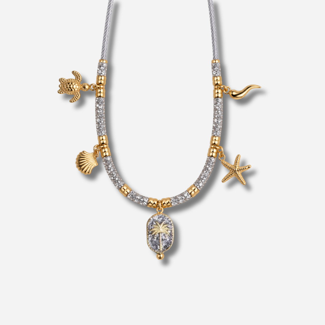 Collier Palombaggia Palmier Argent Amadrina en acier doré 18K avec cristaux argentés, palmier central et pampilles marines