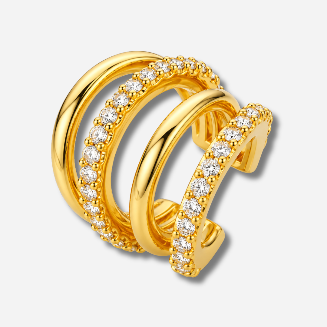 Earcuff Soho Gold MYA BAY composé de quatre anneaux dorés parallèles, deux lisses et deux sertis de cristaux blancs scintillants, chez Divinity Sète.